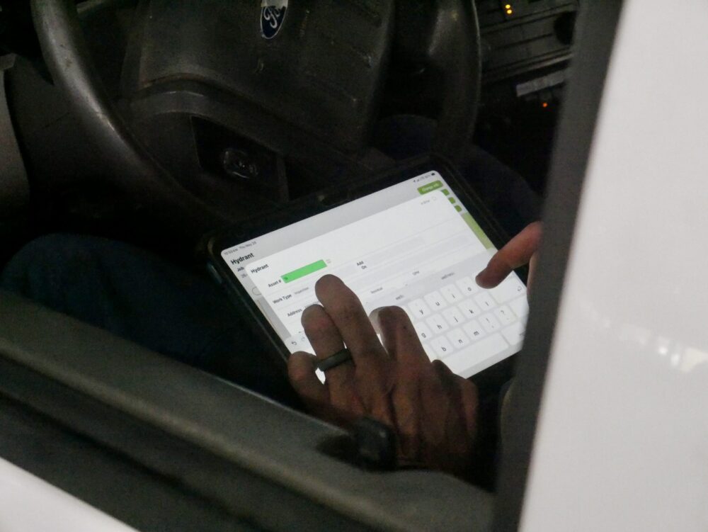 Field worker entering data into a tablet using the MARS™ program