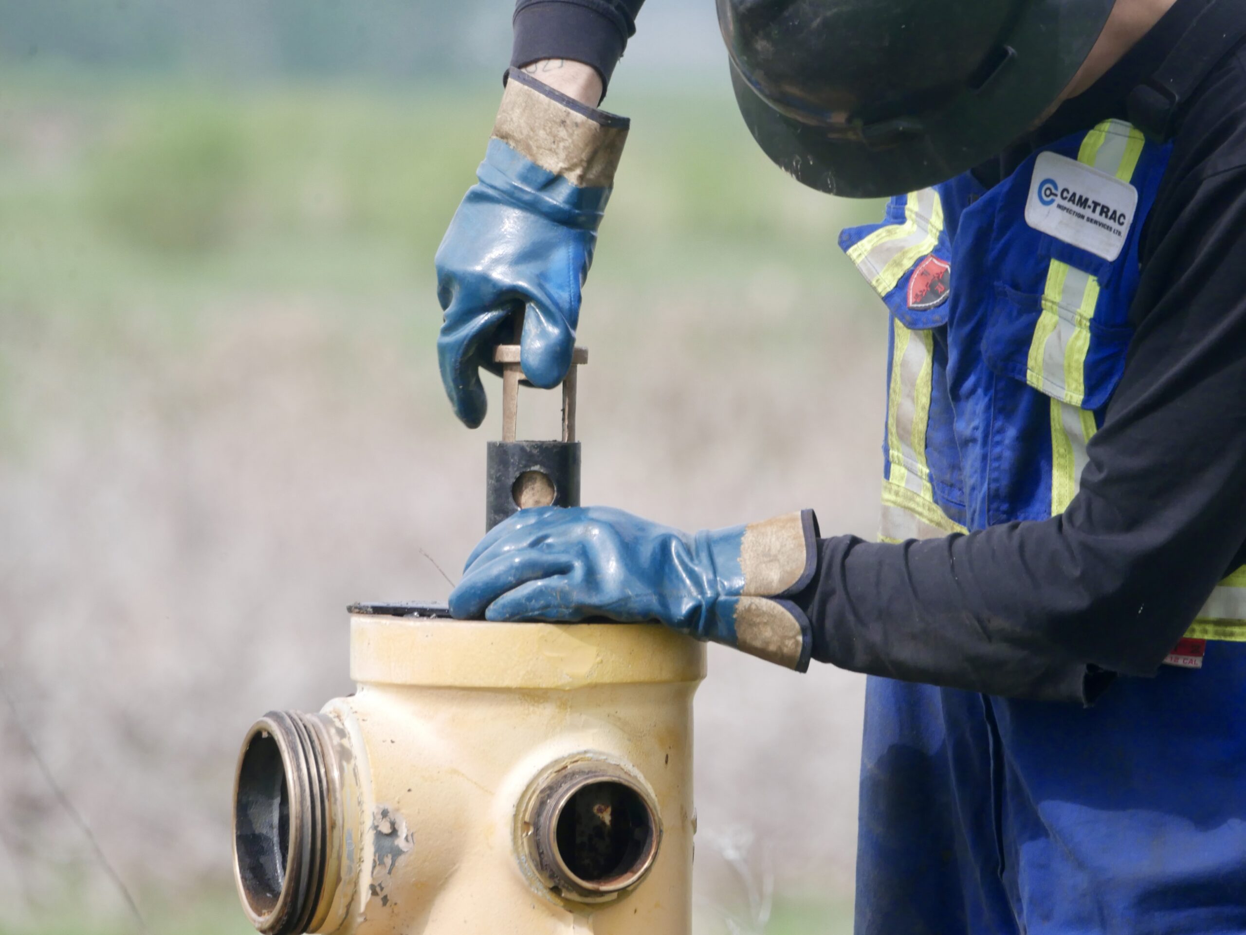Field worker performing work on a fire hydrant