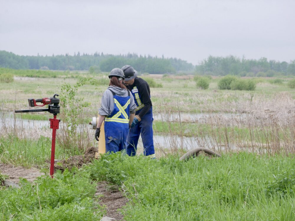 Man and woman field workers performing hydrant maintenance as a team at a job site
