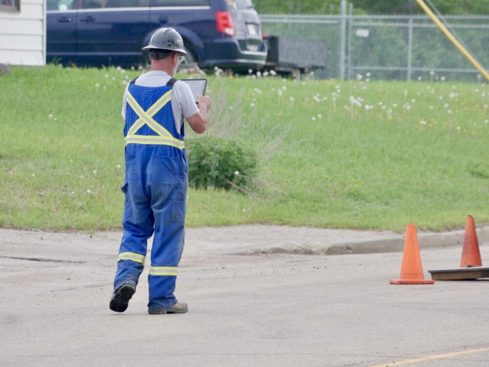 Cam-Trac field worker taking site photos to document conditions before adding information to MARS™.