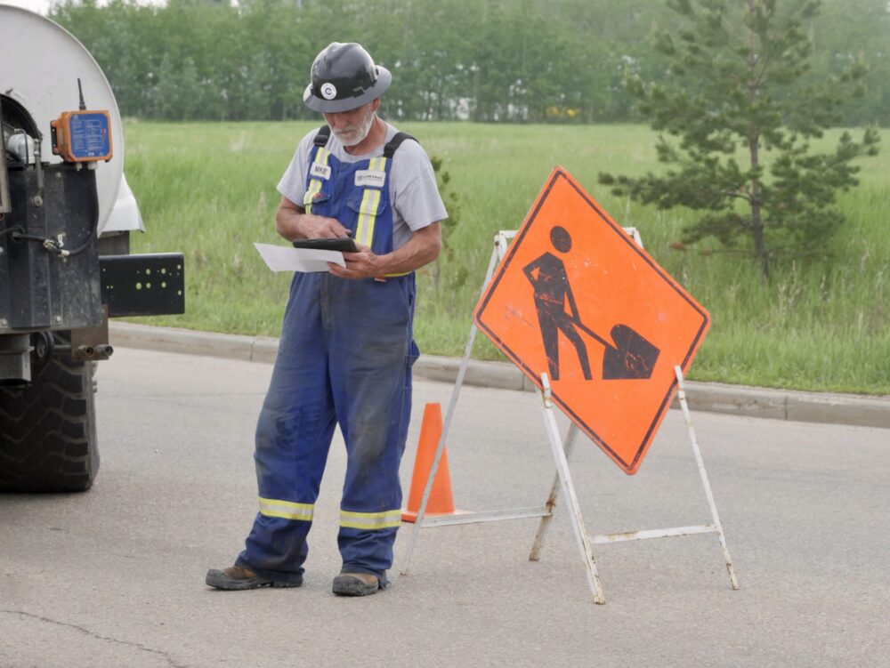 Field worker entering MARS™ data into a tablet at an active job site