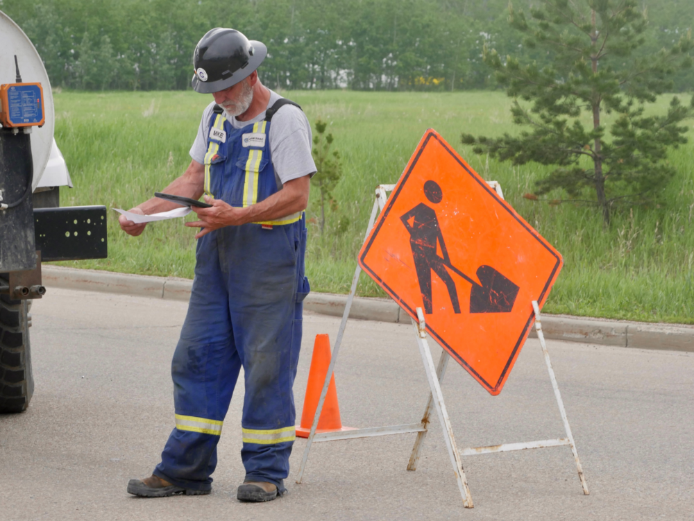 Field operator entering data into MARS software at an active job site
