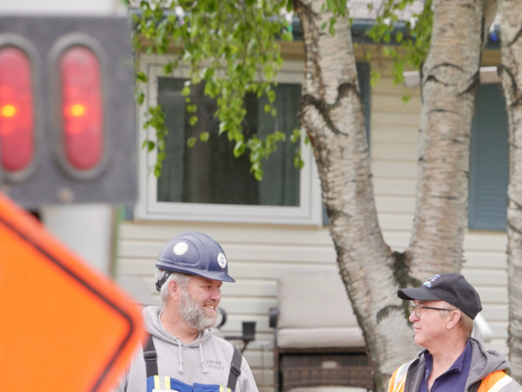 Cam-Trac owner visiting a job site and speaking with field workers